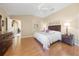 Bright bedroom featuring hardwood floors and ceiling fan at 2304 Grenadier Way, The Villages, FL 32162