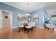 Elegant dining area with hardwood floors and light blue walls at 2304 Grenadier Way, The Villages, FL 32162