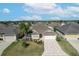 One-story house with a two-car garage and landscaped yard at 2304 Grenadier Way, The Villages, FL 32162