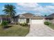 One-story house with a two-car garage and landscaped yard at 2304 Grenadier Way, The Villages, FL 32162