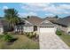 One-story house with a two-car garage and landscaped yard at 2304 Grenadier Way, The Villages, FL 32162