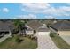 One-story house with a two-car garage and landscaped yard at 2304 Grenadier Way, The Villages, FL 32162