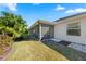 Home exterior showcasing a screened porch and yard at 2304 Grenadier Way, The Villages, FL 32162