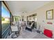 Relaxing screened porch with patio furniture at 2304 Grenadier Way, The Villages, FL 32162