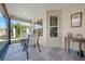 Screened porch with table and chairs at 2304 Grenadier Way, The Villages, FL 32162