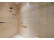 Walk-in shower with tiled walls and grab bar at 2304 Grenadier Way, The Villages, FL 32162