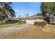 View of the house's garage and driveway, surrounded by well-maintained landscaping at 2575 Se 34Th St, Ocala, FL 34471