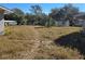 Large backyard with overgrown grass at 36904 Ridge Rd, Fruitland Park, FL 34731