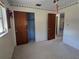 Bedroom with double door closet and neutral carpet at 36904 Ridge Rd, Fruitland Park, FL 34731