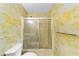 Small bathroom with shower, toilet and bamboo wallpaper at 3827 Ne 17Th Street Cir, Ocala, FL 34470