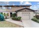 Two-story townhome with attached garage and manicured landscaping at 3827 Ne 17Th Street Cir, Ocala, FL 34470