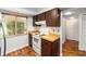 View of kitchen with white appliances and wood cabinets at 3827 Ne 17Th Street Cir, Ocala, FL 34470