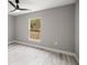 Bedroom with wood-look flooring and large window at 4335 Sw 159Th Ave, Ocala, FL 34481