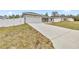 Long concrete driveway leading to a two-car garage at 4335 Sw 159Th Ave, Ocala, FL 34481