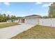 Newly built home with driveway and a white privacy fence at 4353 Sw 159Th Ave, Ocala, FL 34481