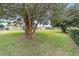 Large backyard with mature trees and home view at 4535 Nw 34Th Pl, Ocala, FL 34482