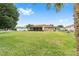 Spacious backyard with lush lawn and home view at 4535 Nw 34Th Pl, Ocala, FL 34482