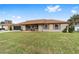 Tan house with brown roof, screened porch, and green yard at 4535 Nw 34Th Pl, Ocala, FL 34482