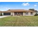 Tan house with brown roof, screened porch, and large yard at 4535 Nw 34Th Pl, Ocala, FL 34482