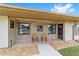 Brick front porch with two chairs and decorative accents at 4535 Nw 34Th Pl, Ocala, FL 34482