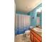 Clean bathroom with blue walls and a shower/tub combo at 4730 Se 31St St, Ocala, FL 34480