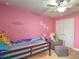 Another bedroom with pink walls and playful decor at 4730 Se 31St St, Ocala, FL 34480