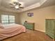 Main bedroom with carpeted floors, ceiling fan, and a large dresser at 4730 Se 31St St, Ocala, FL 34480