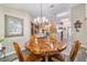 Bright dining room featuring a unique wood table and antler chandelier at 4933 Sw 109Th Loop, Ocala, FL 34476