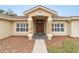 Home entrance with stone columns and a wooden door at 4933 Sw 109Th Loop, Ocala, FL 34476