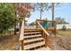 Wooden deck stairs leading to a backyard pool area at 4933 Sw 109Th Loop, Ocala, FL 34476