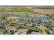 Aerial view of homes near a golf course and pond at 6751 Sw 91St Cir, Ocala, FL 34481