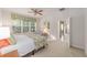 Bright bedroom with a queen bed and access to a balcony at 6751 Sw 91St Cir, Ocala, FL 34481