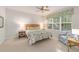 Cozy bedroom with a queen-size bed and sitting area at 6751 Sw 91St Cir, Ocala, FL 34481