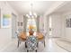 Elegant dining room with round table and statement chandelier at 6751 Sw 91St Cir, Ocala, FL 34481