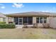 Home exterior showcasing screened porch and landscaped yard at 6751 Sw 91St Cir, Ocala, FL 34481