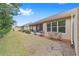 Side yard view of home with screened porch and manicured lawn at 6751 Sw 91St Cir, Ocala, FL 34481