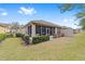 Backyard view of home with screened porch and lush landscaping at 6751 Sw 91St Cir, Ocala, FL 34481