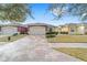 House exterior with a two-car garage and landscaping at 6751 Sw 91St Cir, Ocala, FL 34481