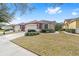 House exterior with a two-car garage and landscaping at 6751 Sw 91St Cir, Ocala, FL 34481