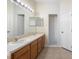 Bathroom boasts double sinks, wood cabinets, and a shower at 7000 Sw 129Th Pl, Ocala, FL 34473