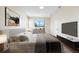 Main bedroom with large window and staged furniture at 7000 Sw 129Th Pl, Ocala, FL 34473