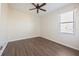 Spacious bedroom featuring wood-look floors and a ceiling fan at 7000 Sw 129Th Pl, Ocala, FL 34473