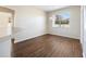 Bright dining room with wood-look floors and a large window at 7000 Sw 129Th Pl, Ocala, FL 34473