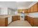 Kitchen features wood cabinets and white appliances at 7000 Sw 129Th Pl, Ocala, FL 34473