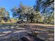 Serene backyard with sprawling oak tree and wooden fence at 9100 Se 180Th Avenue Rd, Ocklawaha, FL 32179