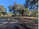 Spacious backyard with large oak trees and wooden fence at 9100 Se 180Th Avenue Rd, Ocklawaha, FL 32179