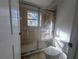 Bathroom with shower and tub, window, and tiled walls at 9100 Se 180Th Avenue Rd, Ocklawaha, FL 32179