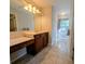 Main bathroom with double vanity, window, and tiled floor at 9100 Se 180Th Avenue Rd, Ocklawaha, FL 32179