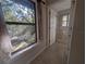 Bedroom with window overlooking backyard and access to bathroom at 9100 Se 180Th Avenue Rd, Ocklawaha, FL 32179