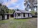 Small white cottage with outbuildings at 9100 Se 180Th Avenue Rd, Ocklawaha, FL 32179